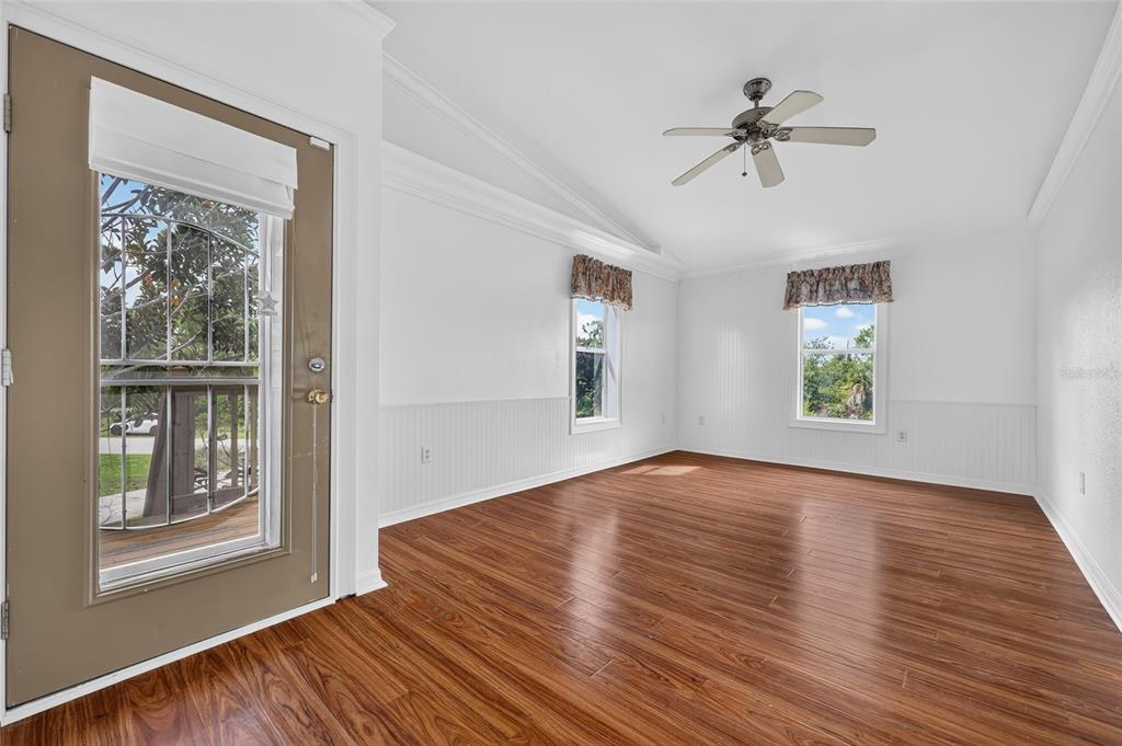 An aerial view shows a two-story house with a metal roof and a backyard pool — 5220 ANDERSON ROAD, PORT CHARLOTTE, FL