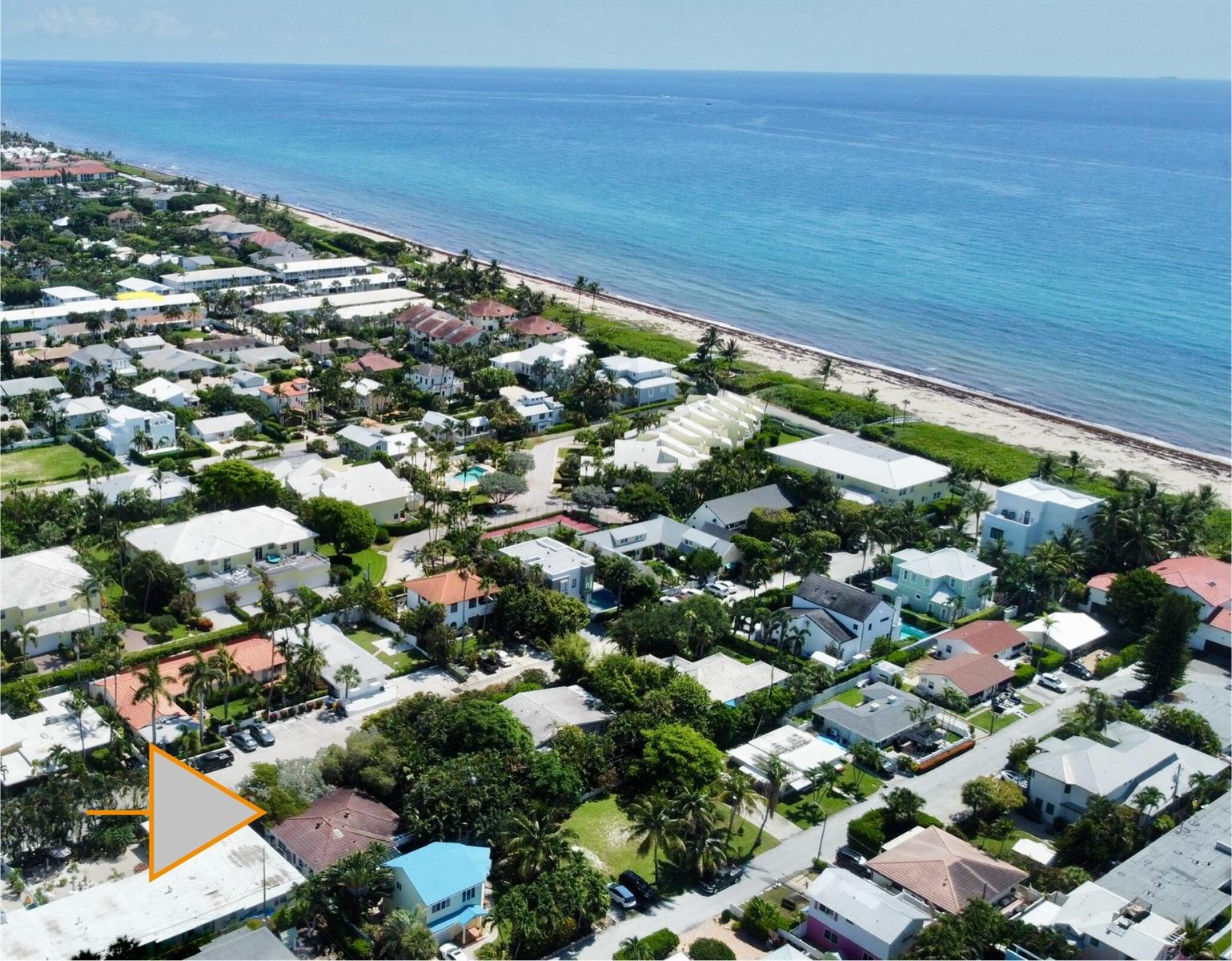 An aerial view of a coastal neighborhood with houses, lush trees, and a sandy beach — 14 Tropical Drive, Ocean Ridge FL 33435, OCEAN RIDGE, FL