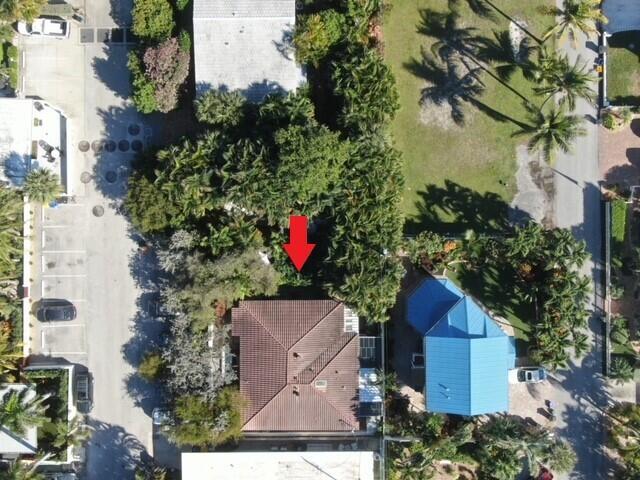 An aerial view shows a house with a brown tiled roof surrounded by dense trees — 14 Tropical Drive, Ocean Ridge FL 33435, OCEAN RIDGE, FL