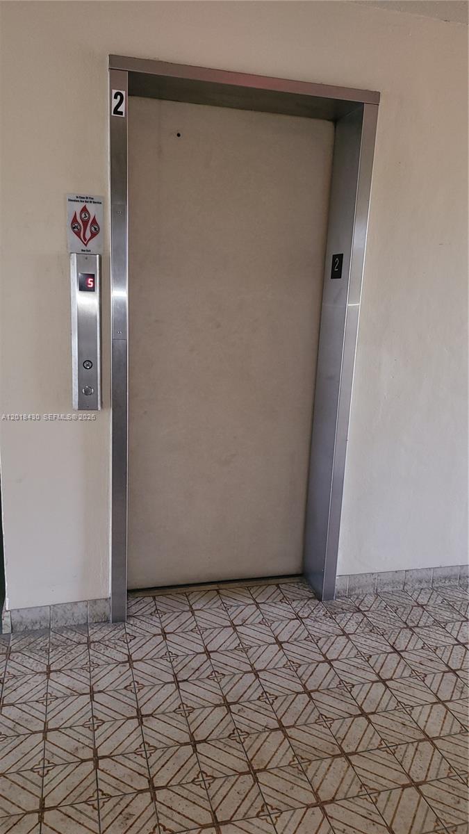 An elevator door with a digital floor indicator is set into a plain wall — 1001 NE 14th Ave # 201, Hallandale Beach FL 33009, HALLANDALE BEACH, FL