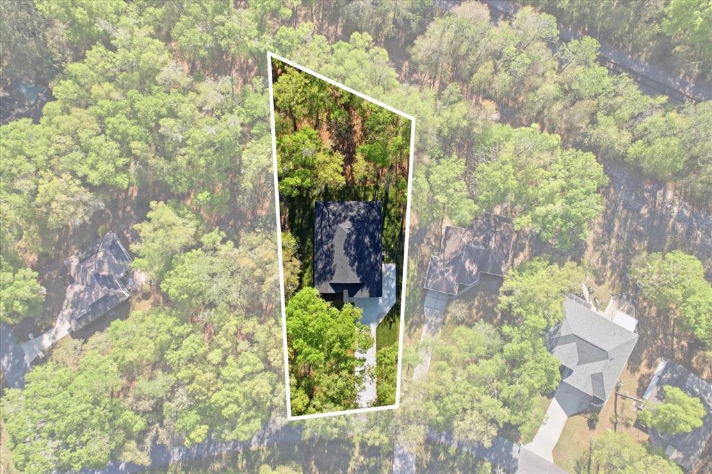 An aerial view shows a house on a wooded lot outlined in white — 19126 SW 101ST STREET, DUNNELLON, FL