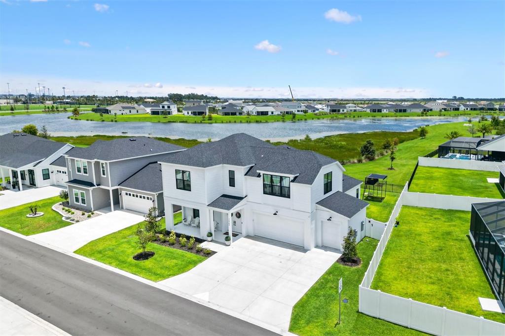 An aerial view shows a two-story white house with a dark roof and driveway — 7969 BYERS ST, MIDDLETON, FL