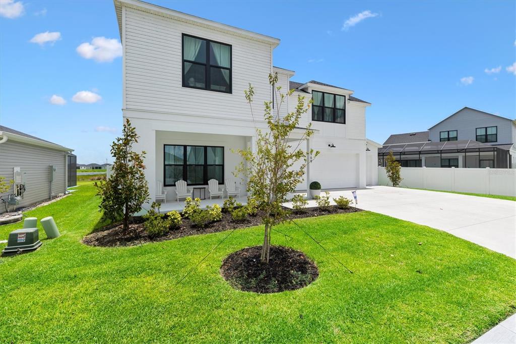 A two-story white house with black window frames and a front porch — 7969 BYERS ST, MIDDLETON, FL