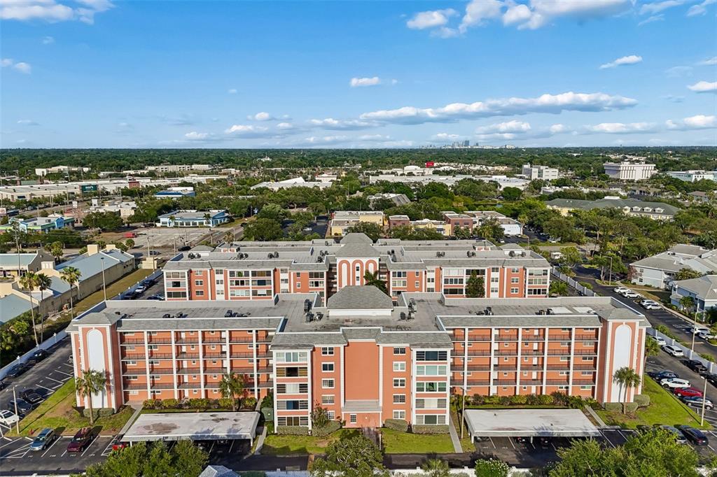 An aerial view of a multi-story residential apartment complex with a central courtyard and parking — 6960 20TH AVENUE N UNIT 501, ST PETERSBURG, FL