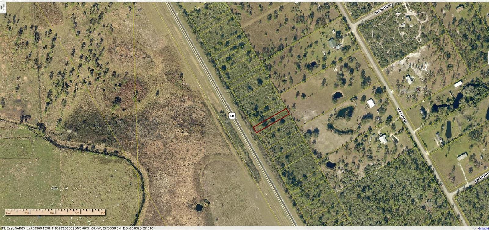 An aerial map shows a rectangular parcel of land highlighted in red along a highway — 0 N Hwy 441, Okeechobee FL 34972, OKEECHOBEE, FL