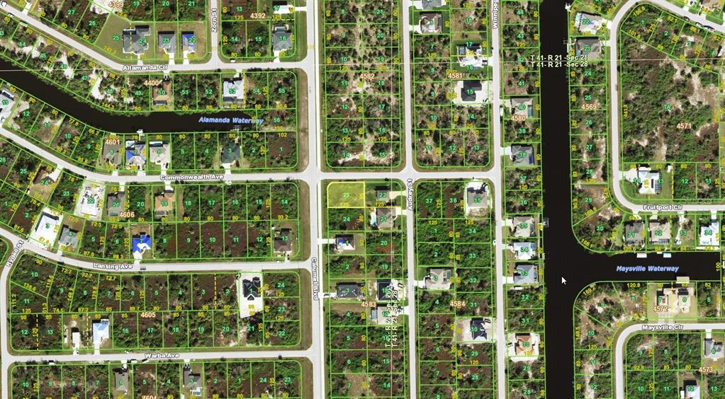 This is a satellite map view of a residential neighborhood with canals and vacant lots — 10044 CALUMET BOULEVARD, PORT CHARLOTTE, FL