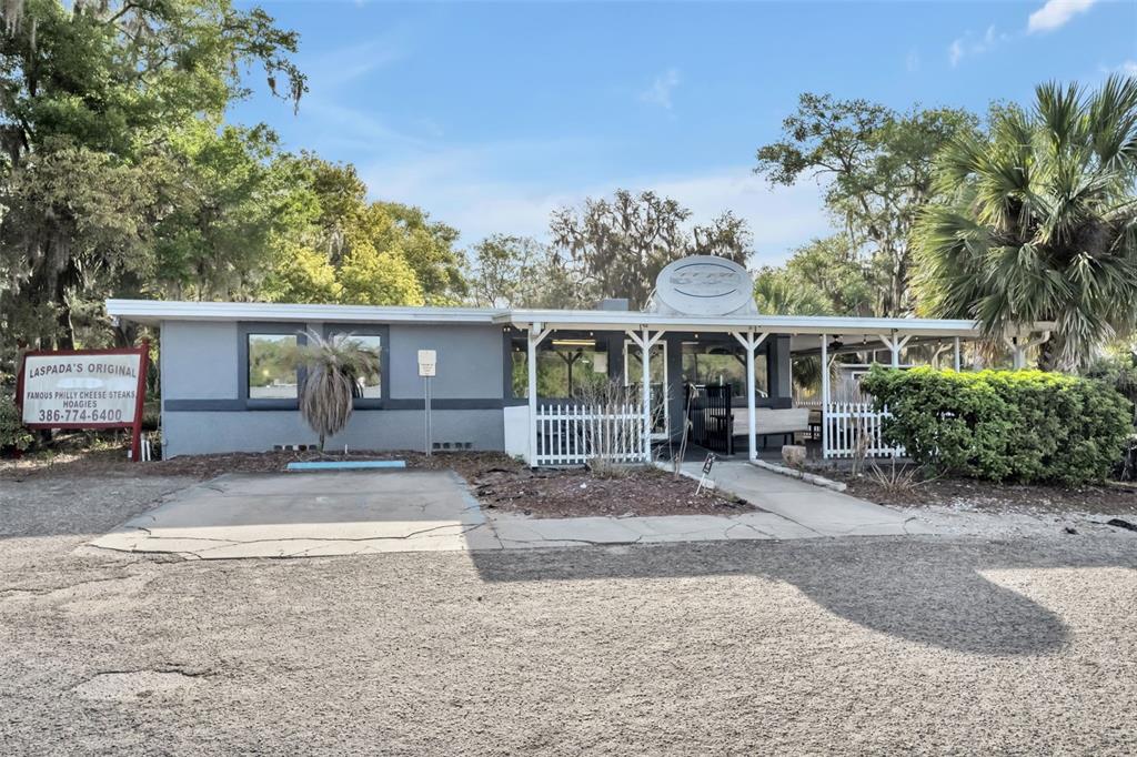 A single-story restaurant building with a covered porch and a gravel parking lot — 2200 N VOLUSIA AVENUE, ORANGE CITY, FL