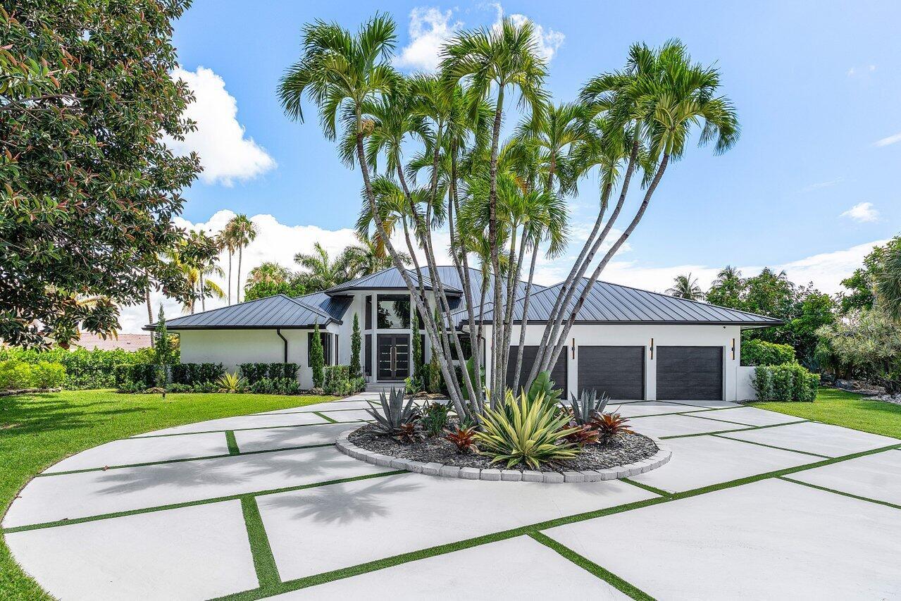 A modern single-story house with a metal roof and a circular concrete driveway — 4825 Bocaire Boulevard, Boca Raton FL 33487, BOCA RATON, FL