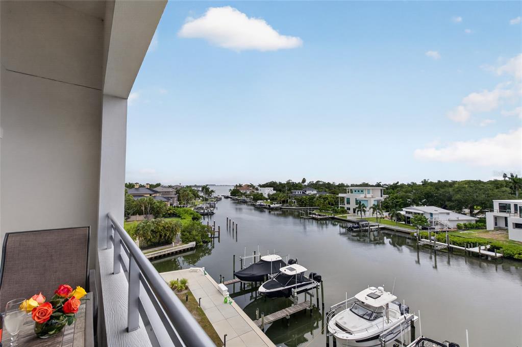 A balcony overlooks a canal lined with houses and private boat docks — 1709 N TAMIAMI TRAIL UNIT 505, SARASOTA, FL