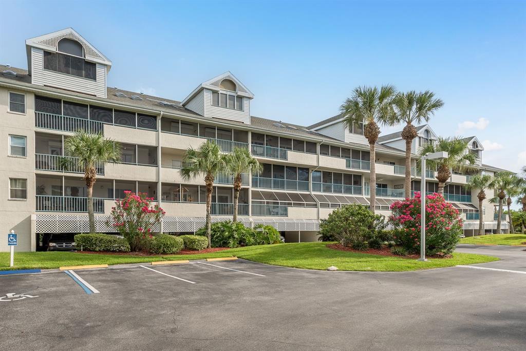 A kitchen with white cabinets, granite countertops, stainless steel appliances, and wood-look flooring — 5557 SEA FOREST DRIVE UNIT 118, NEW PORT RICHEY, FL