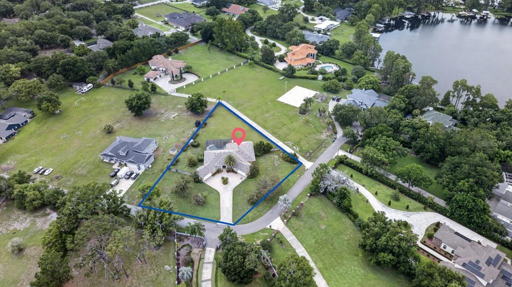 An aerial view shows a single-story house with a circular driveway on a large lot — 9427 EDDINGS ROAD, ODESSA, FL