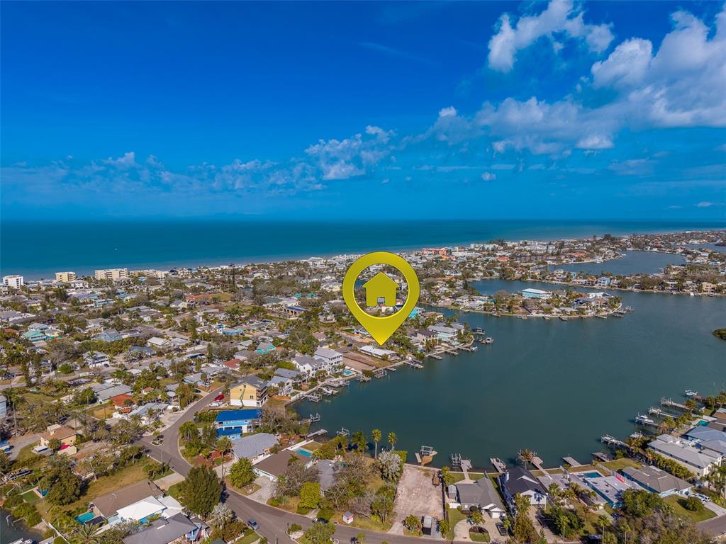 An aerial view shows a coastal neighborhood with a house marked by a yellow icon — 1217 BAY SHORE BOULEVARD, INDIAN ROCKS BEACH, FL