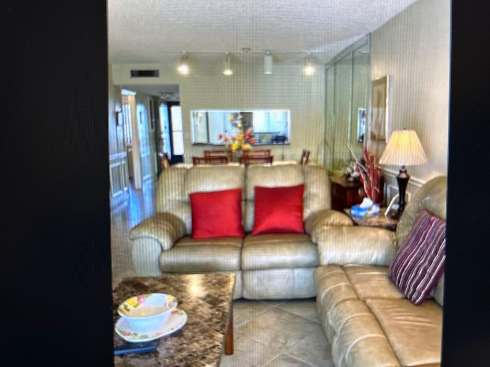 A living room features light-colored leather sofas, a marble-topped coffee table, and tiled flooring — 3212 Strawflower Way, FL 33467, FL