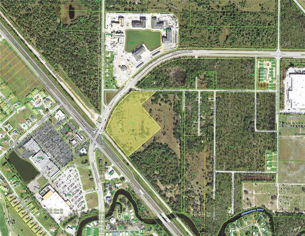 This is an aerial map showing a highlighted parcel of land near a highway intersection — 10000 TAMIAMI TRAIL, PUNTA GORDA, FL