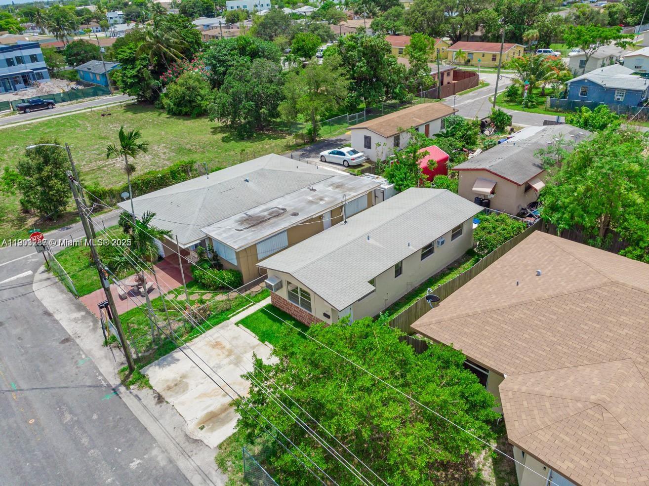 An aerial view shows two adjacent single-story houses with driveways and surrounding trees — 805 NW 3rd Ter # 1, Hallandale Beach FL 33009, HALLANDALE BEACH, FL