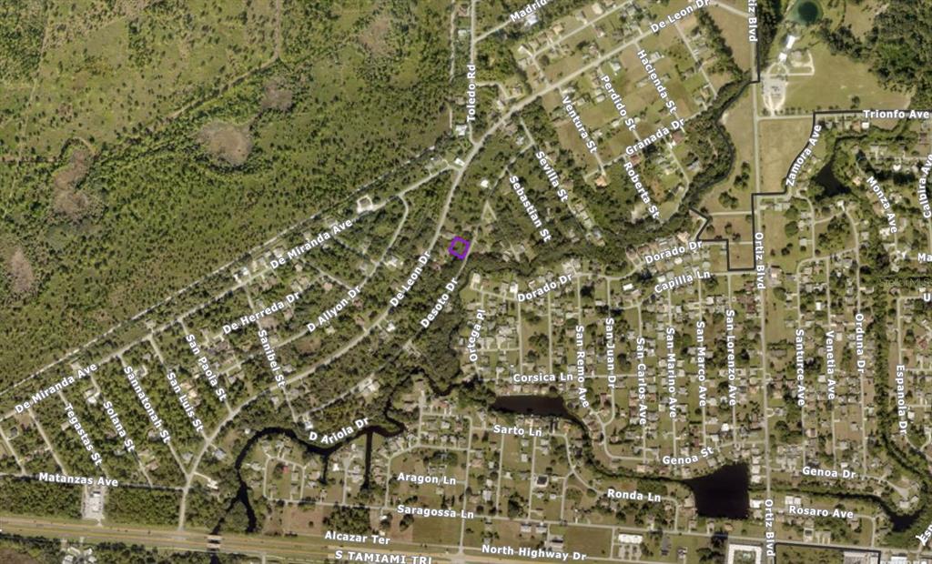 This is an aerial map showing residential streets and undeveloped land in a suburban area — 0770040034 DESOTO DRIVE, NORTH PORT, FL