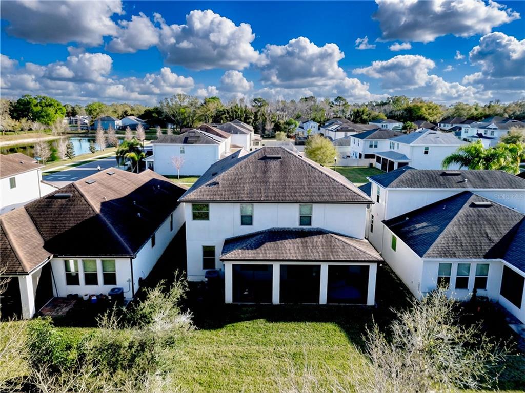 An aerial view shows the back of a two-story house with a screened-in patio — 4892 ECHO COURT UNIT 44, OVIEDO, FL