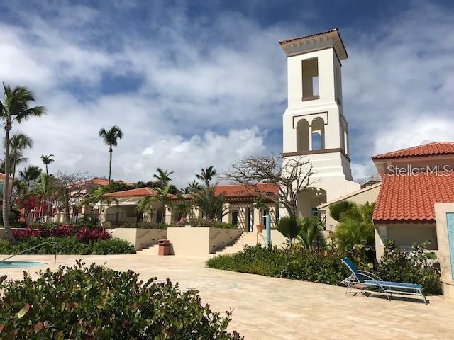 A tall bell tower stands above a resort-style building with a red tile roof — LAS CASITAS VILLAGE 1 AVE CONQUISTADOR UNIT 5391, FAJARDO, PR