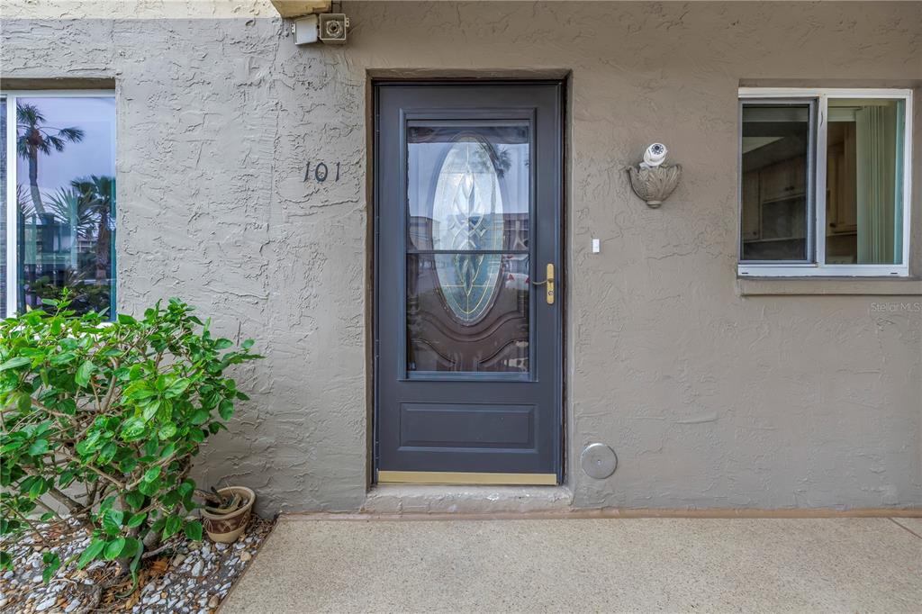 The exterior of a residential unit features a dark front door with a glass insert — 3500 LAKE BAYSHORE DRIVE UNIT K101, BRADENTON, FL