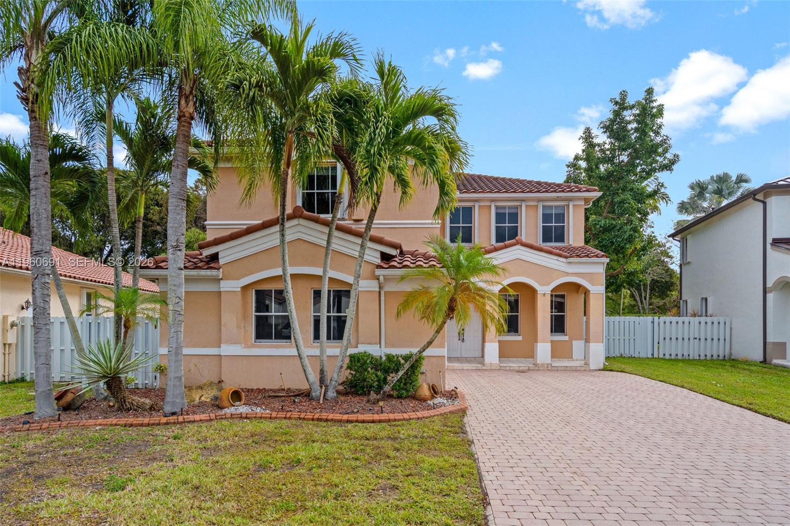 A two-story stucco house with a tiled roof, palm trees, and a paved driveway — 3617 SW 165th Ave, Miramar FL 33027, MIRAMAR, FL
