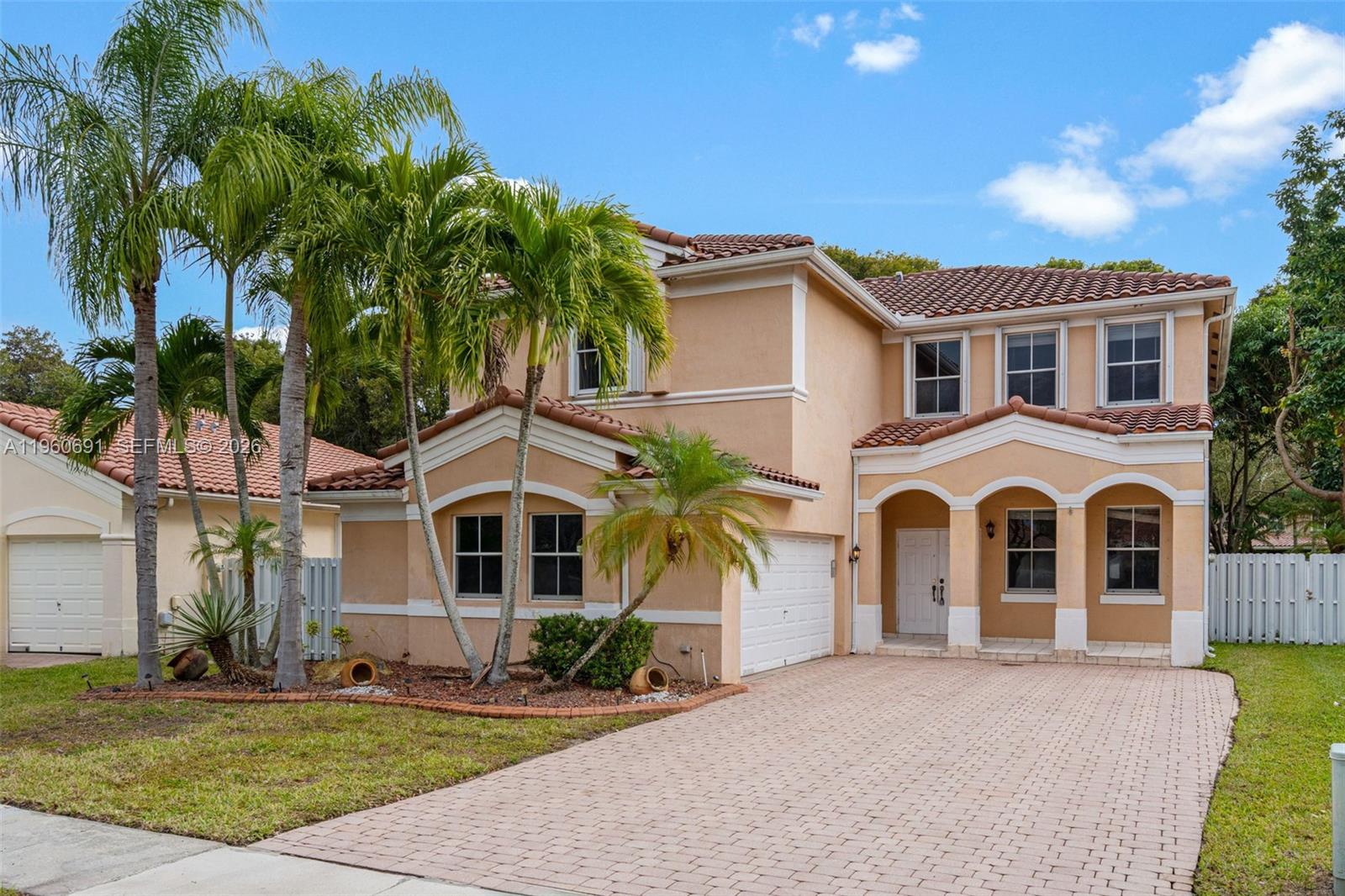 A two-story stucco house with a tile roof, arched entryway, and a paved driveway — 3617 SW 165th Ave, Miramar FL 33027, MIRAMAR, FL