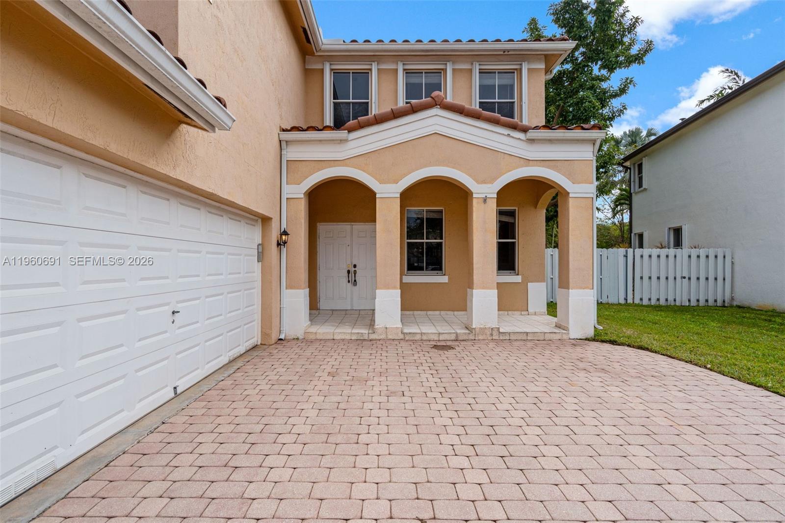 A two-story house features a paved driveway, a white garage door, and a covered entryway — 3617 SW 165th Ave, Miramar FL 33027, MIRAMAR, FL