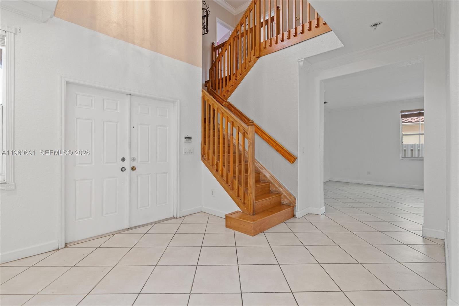 An entryway features white tile floors, a wooden staircase, and double front doors — 3617 SW 165th Ave, Miramar FL 33027, MIRAMAR, FL