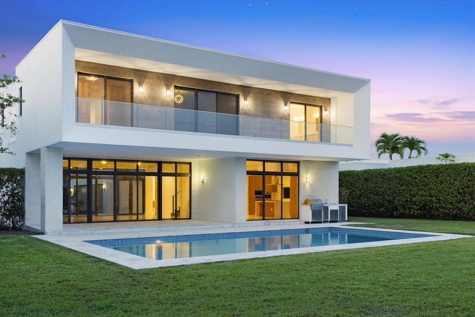 A modern two-story house with a swimming pool, glass balcony, and large sliding glass doors — 16570 Sunset Way, Weston FL 33326, WESTON, FL