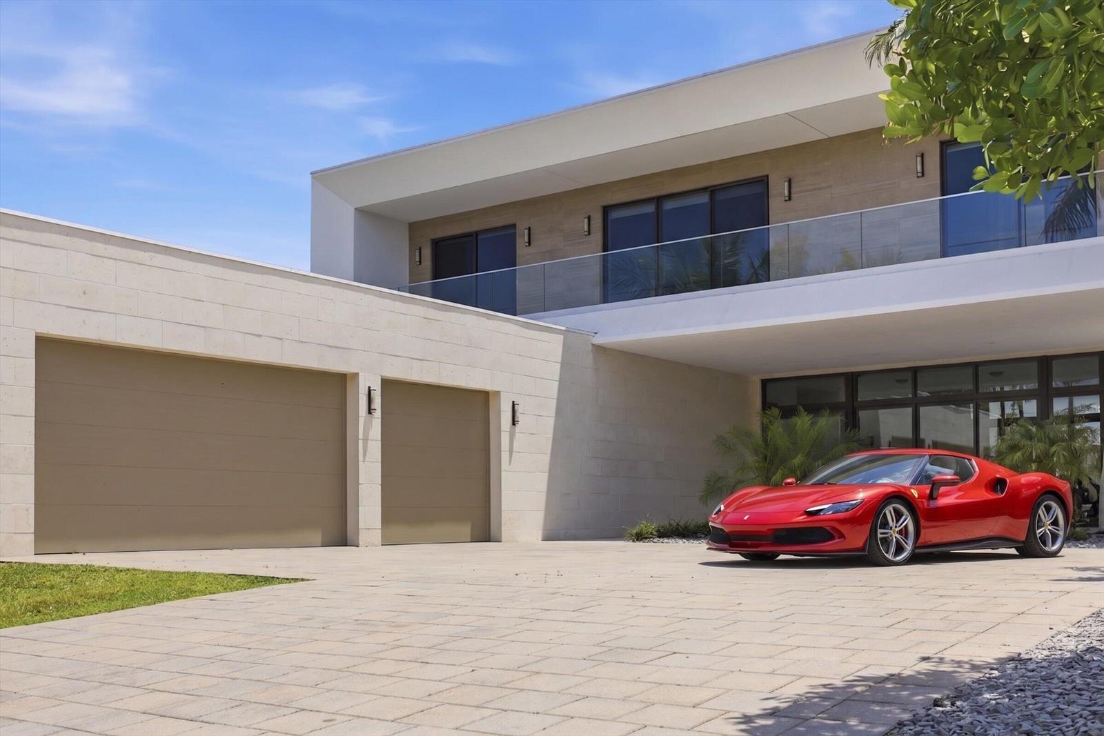 A red sports car is parked in the driveway of a modern two-story stone house — 16570 Sunset Way, Weston FL 33326, WESTON, FL