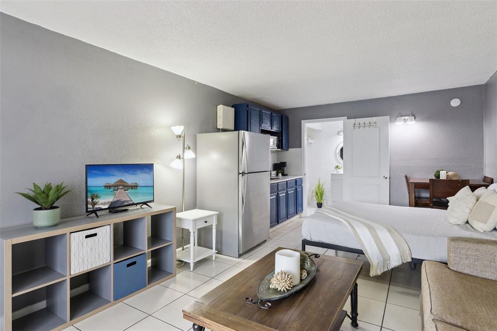 A studio apartment features a kitchenette, a bed, a television, and a coffee table — 43420 HIGHWAY 27 UNIT 464, DAVENPORT, FL