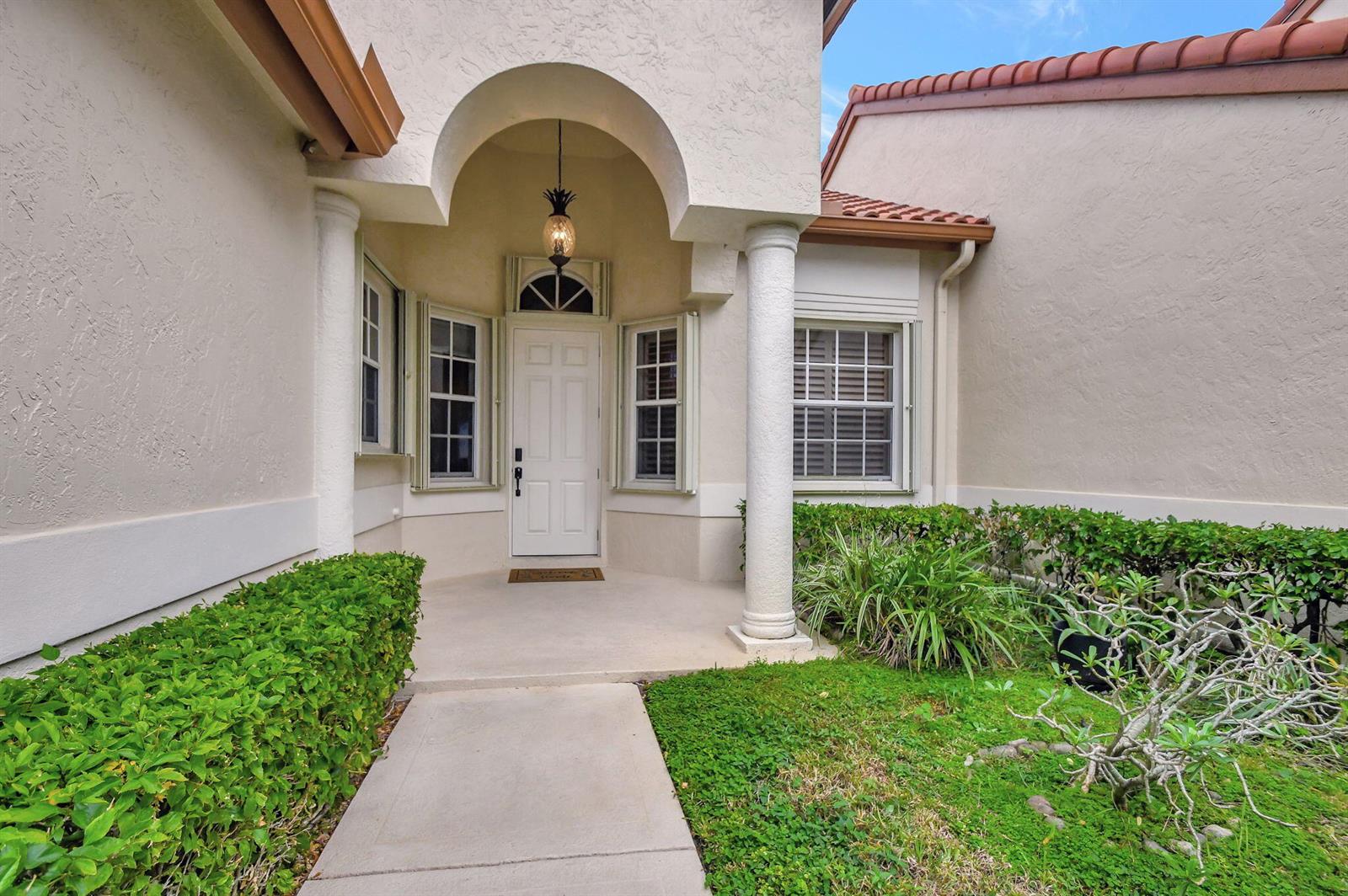 The exterior view shows a white front door under an arched entryway with two columns — 23437 Water Circle, Boca Raton FL 33486, BOCA RATON, FL