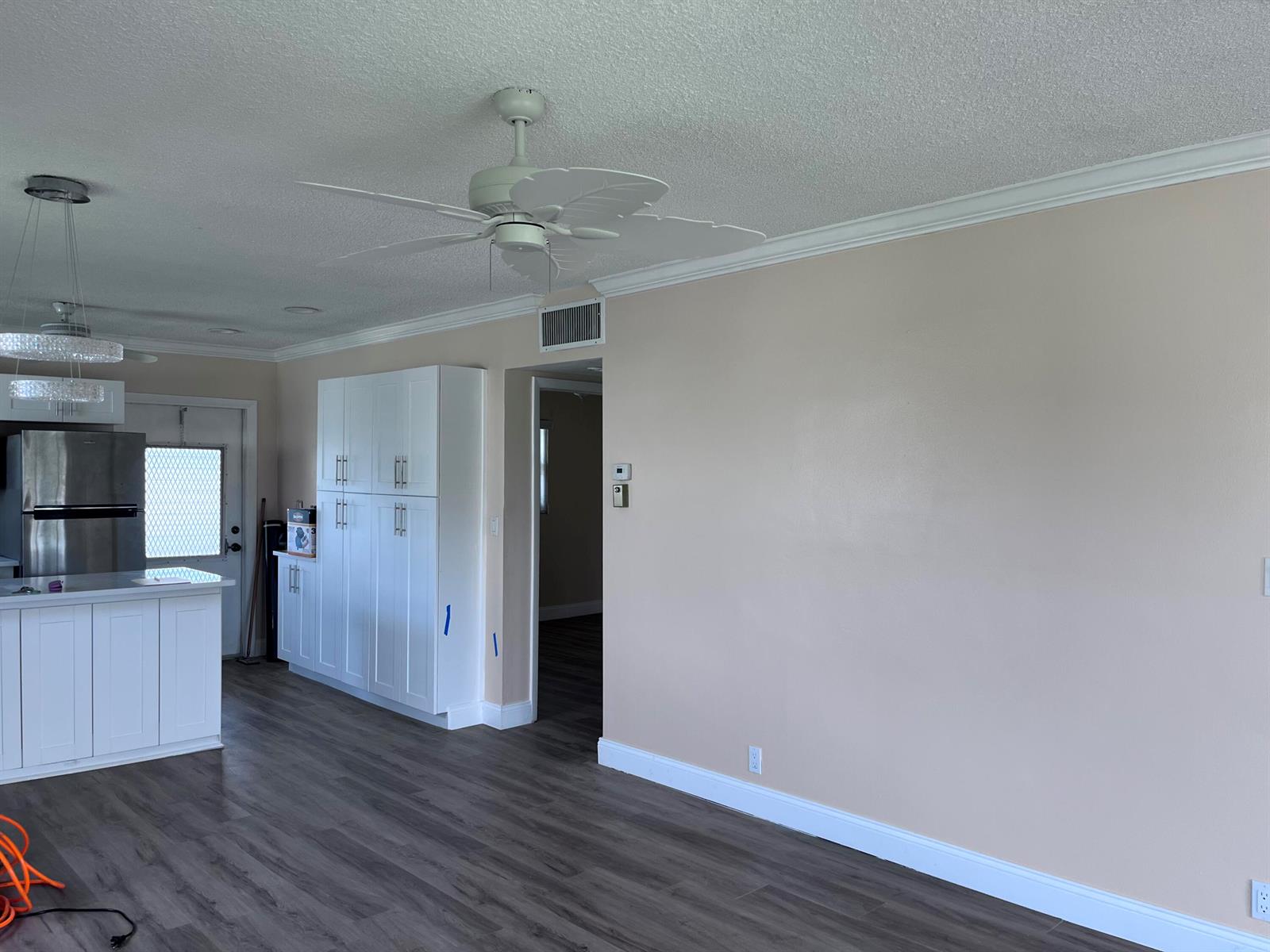 A room with light-colored walls, white cabinetry, a ceiling fan, and dark wood-look flooring — 251 S Golf # 294, Pompano Beach FL 33064, POMPANO BEACH, FL