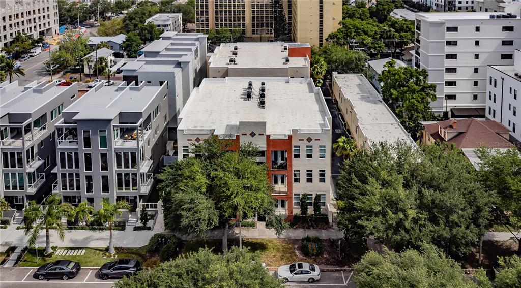 An aerial view shows a multi-story apartment building with a flat roof and balconies — 535 4TH AVENUE S UNIT 4, ST PETERSBURG, FL