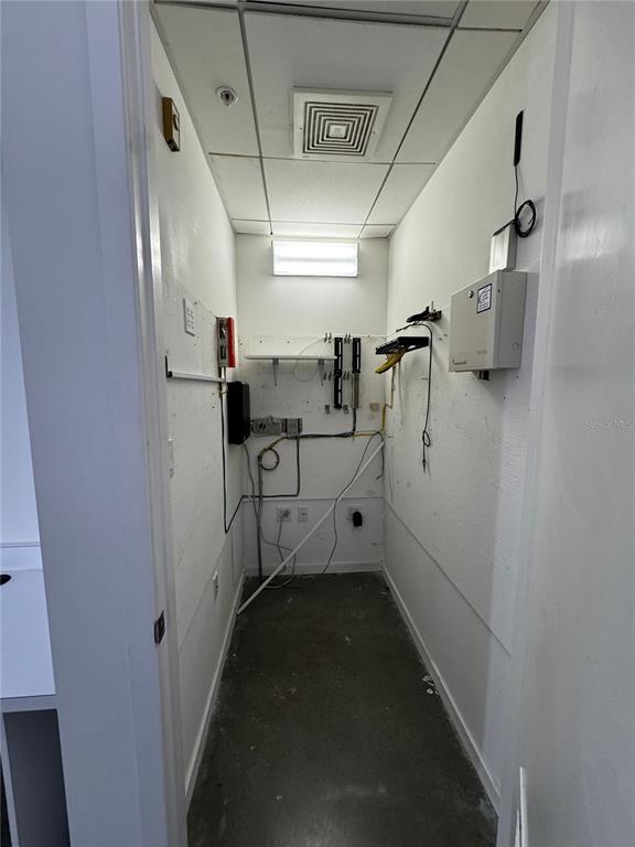 A narrow utility or server room with white walls, exposed wiring, and a drop ceiling — 1348 FRUITVILLE ROAD UNIT 203 & 204, SARASOTA, FL
