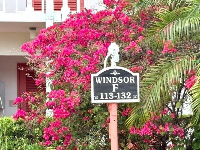 A sign labeled Windsor F 113-132 stands in front of a building with bright pink bougainvillea — 116 Windsor F, West Palm Beach FL 33417, WEST PALM BEACH, FL
