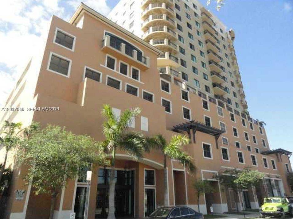 A galley kitchen features wood cabinets, granite countertops, stainless steel appliances, and a tile floor — 4242 NW 2nd St # 901, Miami FL 33126, MIAMI, FL