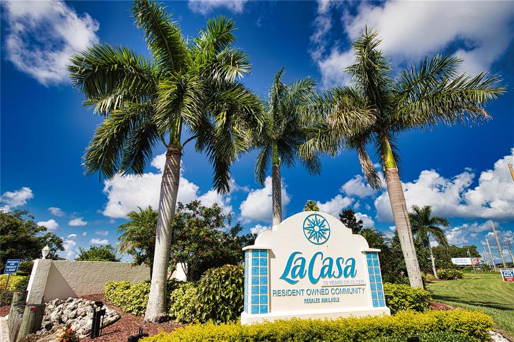 A sign for La Casa 55+ community stands in front of three tall palm trees — 657 ALVARADO, NORTH PORT, FL
