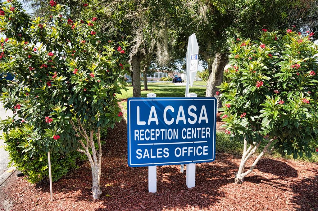 A blue sign for the La Casa Reception Center and Sales Office stands outdoors — 657 ALVARADO, NORTH PORT, FL