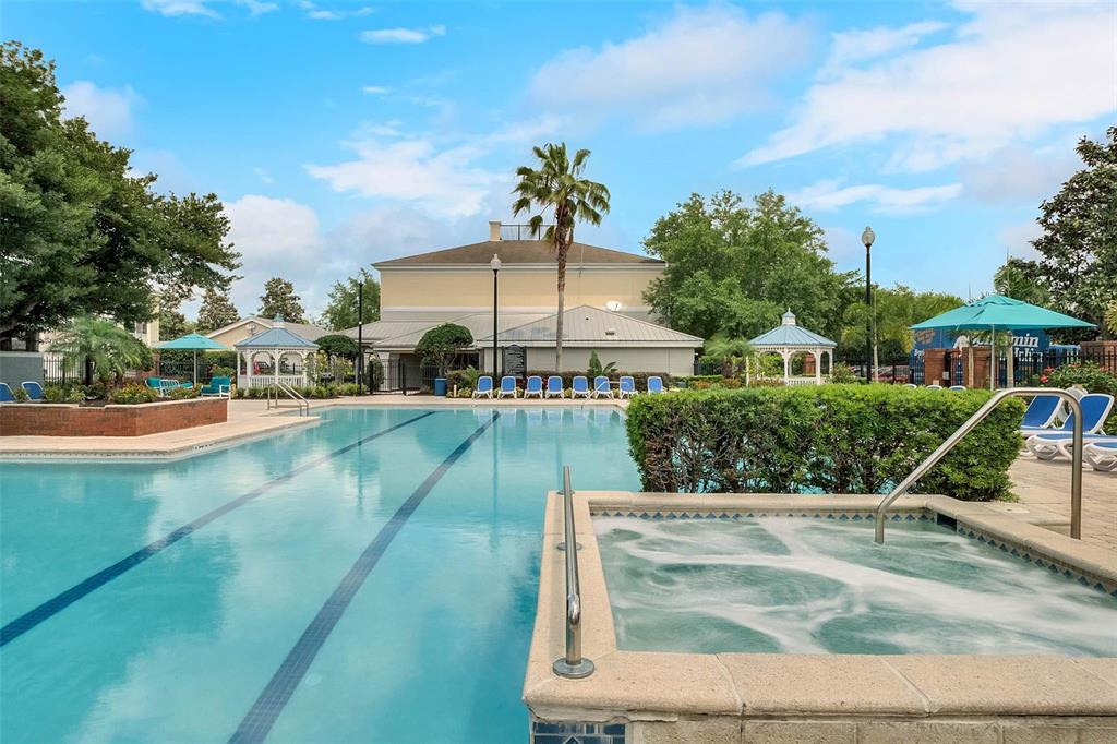 A swimming pool and hot tub are situated in a courtyard with gazebos and landscaping — 3446 SOHO ST UNIT 303, ORLANDO, FL