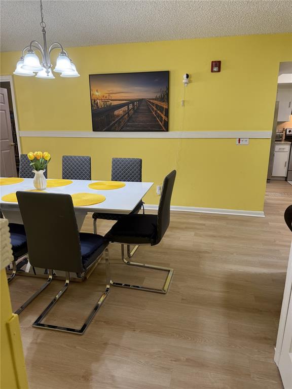A dining room features yellow walls, a white table with gray chairs, and light flooring — 322 REGAL PARK DRIVE, VALRICO, FL