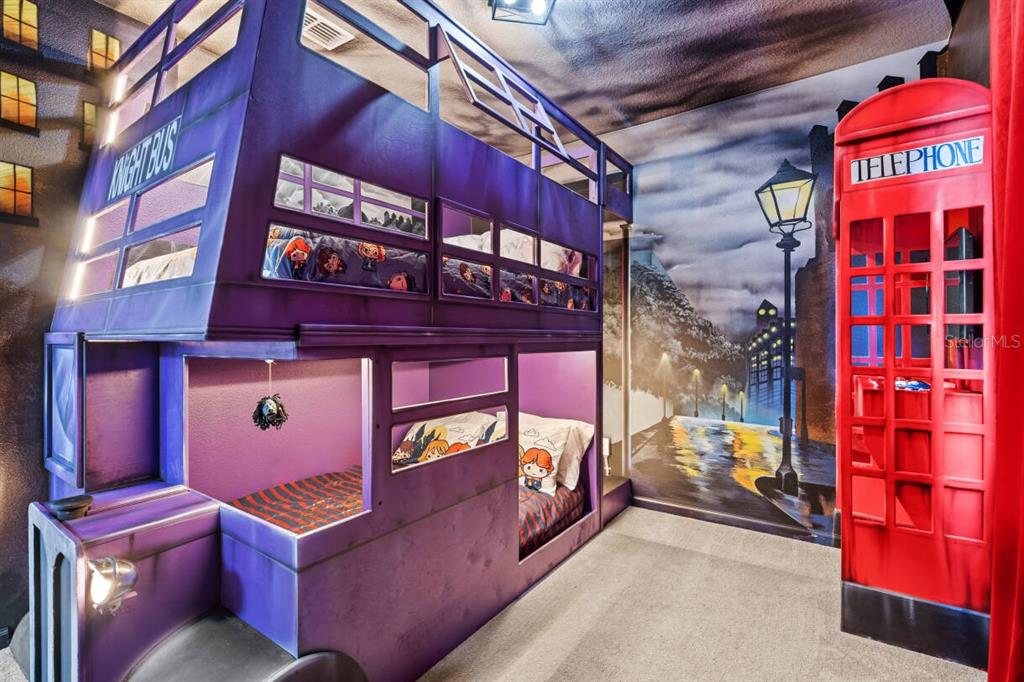 A themed bedroom features a purple Knight Bus bunk bed and a red telephone booth — 5948 HIGH SEAS DRIVE, ORLANDO, FL