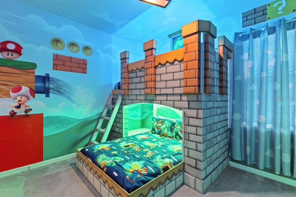 A bedroom features a custom castle-themed bunk bed and Super Mario wall murals — 5948 HIGH SEAS DRIVE, ORLANDO, FL