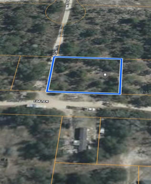 An aerial map view shows a rectangular plot of land outlined in blue — 0 NE 134 TERRACE, WILLISTON, FL