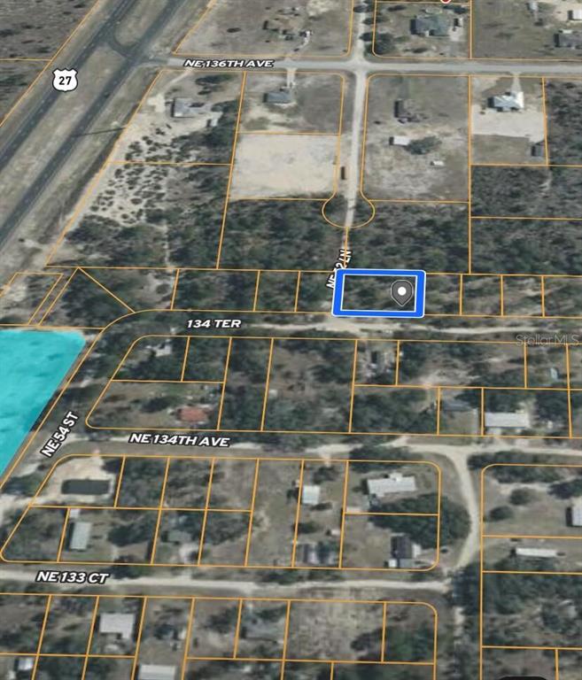 This is an aerial map view showing a highlighted vacant lot in a residential area — 0 NE 134 TERRACE, WILLISTON, FL