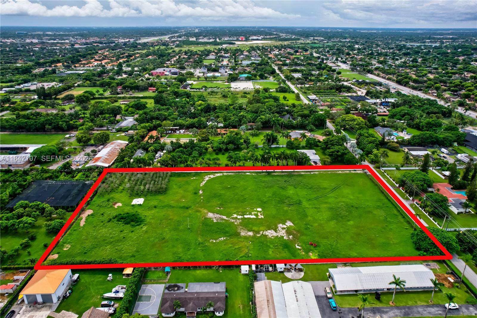 An aerial view shows a large, rectangular vacant lot outlined in red within a neighborhood — 6501 SW 125th Ave, Miami FL 33183, MIAMI, FL
