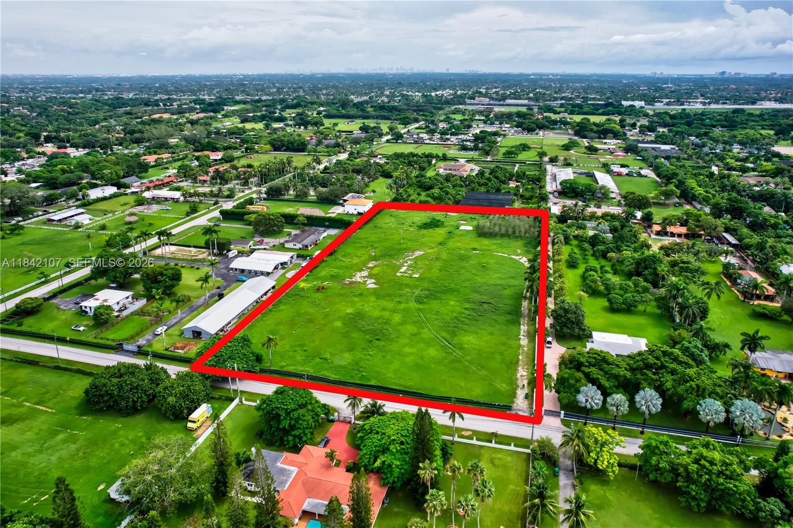 An aerial view shows a large, rectangular vacant lot outlined in red within a residential area — 6501 SW 125th Ave, Miami FL 33183, MIAMI, FL