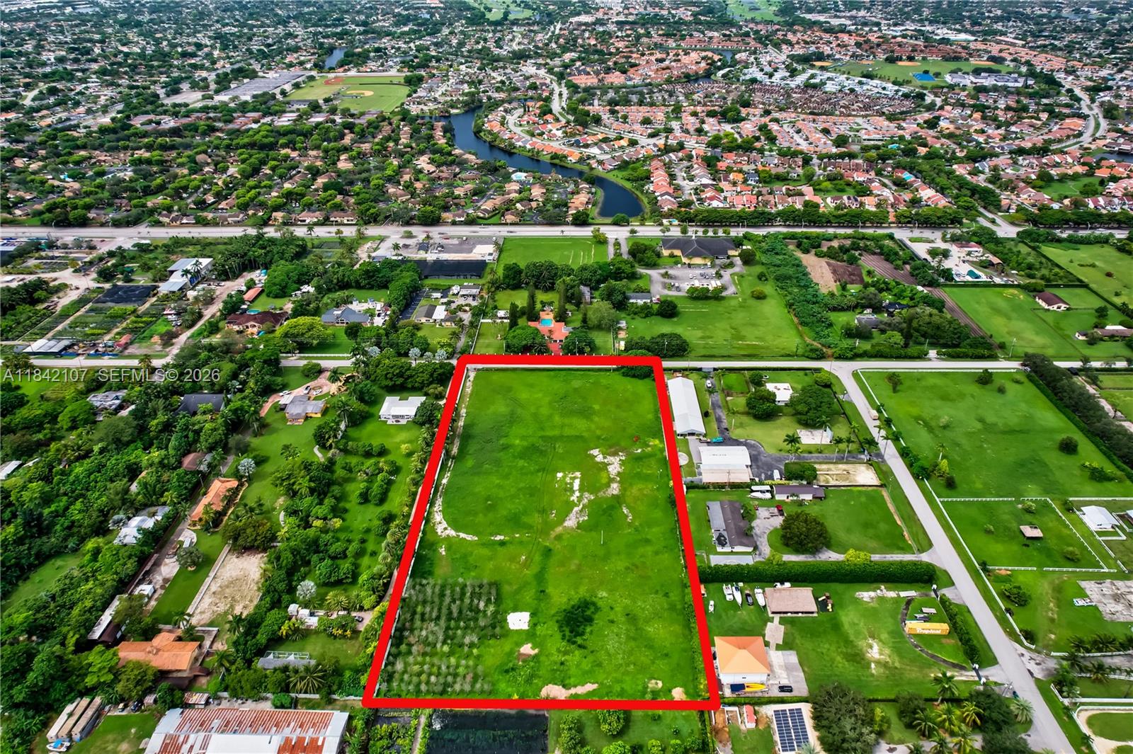 An aerial view shows a large, rectangular vacant lot outlined in red within a neighborhood — 6501 SW 125th Ave, Miami FL 33183, MIAMI, FL