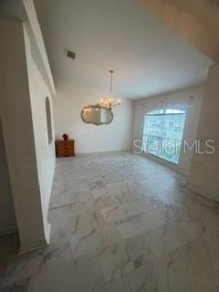 A dining room features white marble flooring, a chandelier, a wall mirror, and a large window — 3010 GREYNOLDS AVENUE, SPRING HILL, FL