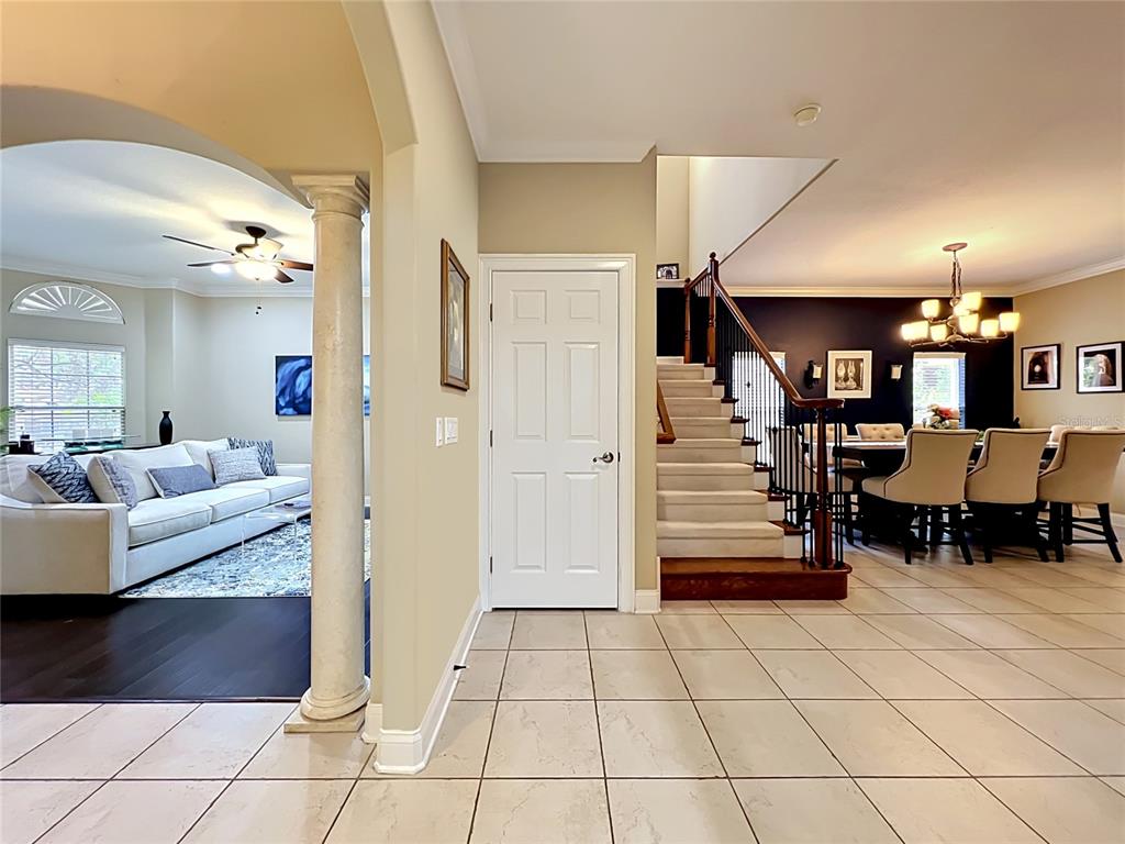 A living room features a fireplace with a white mantel, blue accent walls, and furniture — 6977 DOLCE STREET, ORLANDO, FL