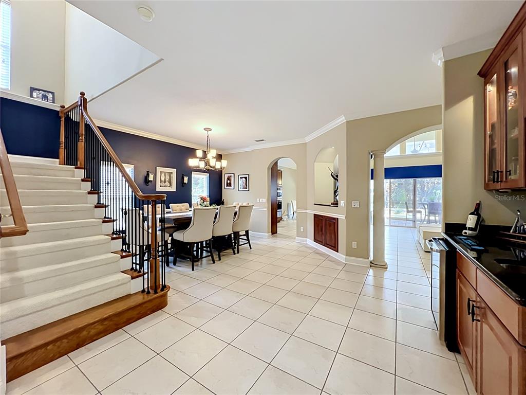 A living room features a white sofa, a blue patterned rug, and a fireplace — 6977 DOLCE STREET, ORLANDO, FL